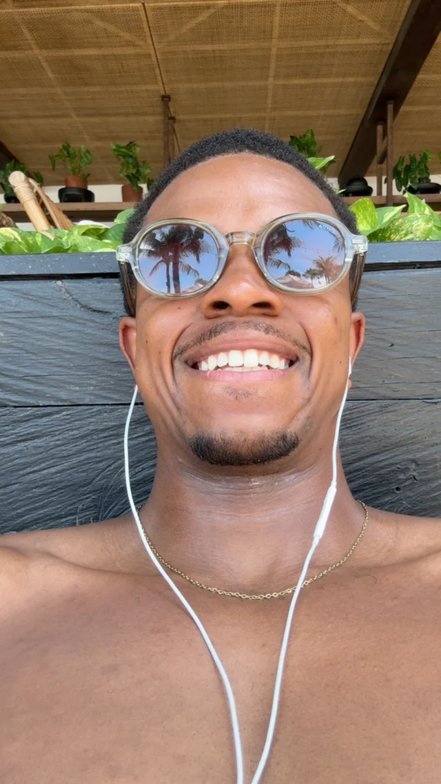 Rio Scott smiling outdoors in sunglasses